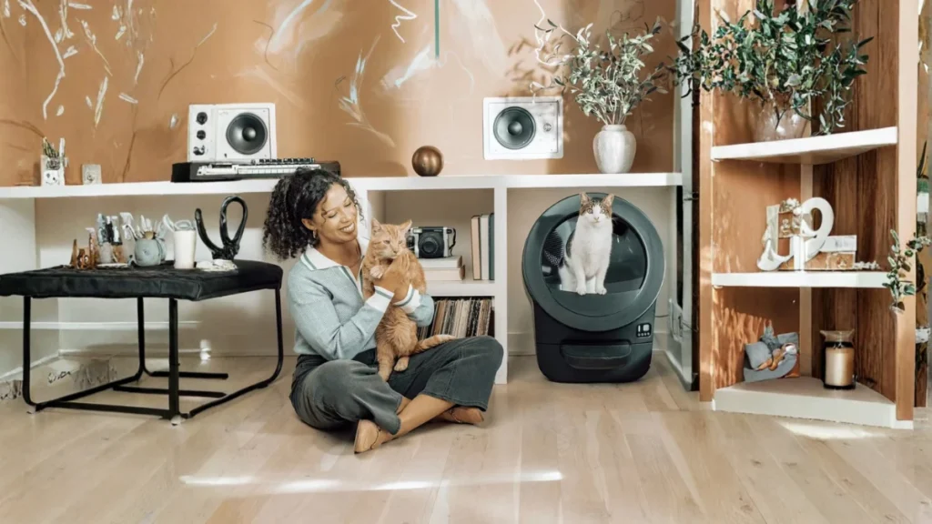 Litter-Robot 4 Review (2026): Is It Worth It or Overhyped? 2 Litter-Robot 4 in a modern home with cat and owner showing real-life use of automatic litter box and smart features