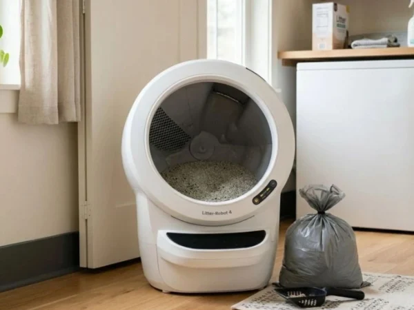 automatic litter box cleaning routine with waste bag and scoop in laundry room